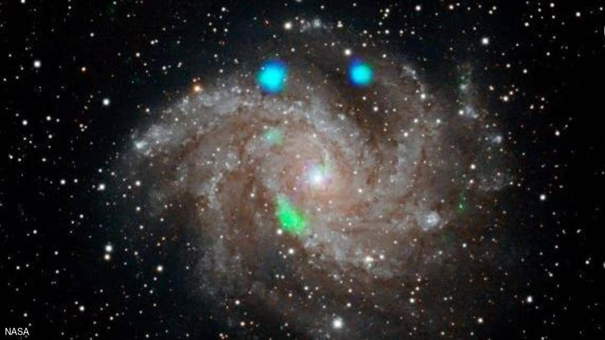 بالصورة: "ناسا" ترصد أضواء غامضة صادرة عن مجرة بعيدة